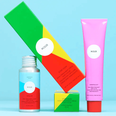 Colorful hair product packaging on a blue background.